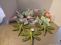 Lot overview showing 3 dragonflies and 8 packaged birds