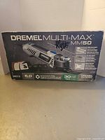 Front of sealed Dremel Multi-Max MM50 kit box showing tool image and branding