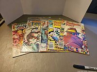 Five Fantastic Four comics fanned out on table