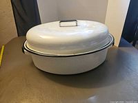 White enamel oval Dutch oven with lid, exterior view