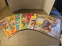 All eight comics laid out in a fan showing covers