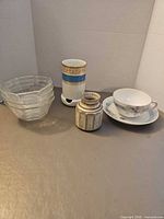 All items grouped: four stacked bowls, Haviland container, stoneware jar, teacup and saucer