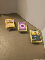 Three stacks of Pokémon cards in lot