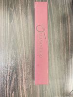 Closed Ollivanders maroon wand box on table