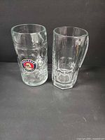 Two glass beer steins side by side