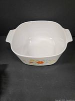 Top view of white square Corning Ware casserole showing interior and handles