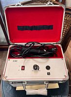 Machine in open carry case showing control panel and cords