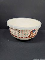 Side view of enamel bowl with lid showing heart grid and rabbit motif