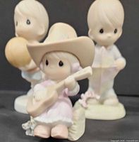All three Precious Moments figurines grouped