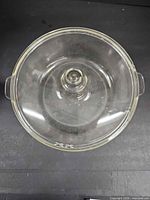 Overhead view of clear glass lid showing knob handle and chip locations