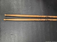 Full pair of drumsticks showing condition and logos