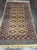 Full view of handmade Turkman rug showing pattern and fringe