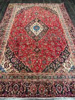 Full view of the Persian Kashan rug showing entire field and borders