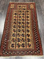 Full view of Baluchi rug showing overall design and colors
