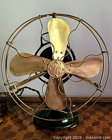 Front view showing brass blades, guard, GE logo medallion, base