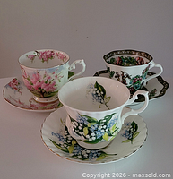 Front view showing three teacup and saucer sets