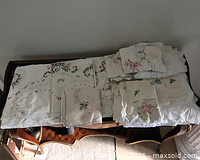 Top view of assorted embroidered linens laid out on table