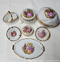 Full set of seven porcelain vanity pieces displayed on cloth background