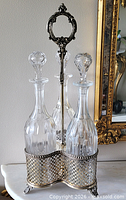full view of cruet stand with three decanters in place