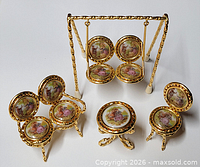 Group shot of all four miniature gilt metal porcelain furniture pieces including swing, loveseat, table, chair