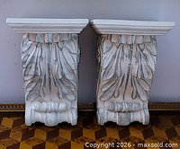 Front view of both plaster corbels showing acanthus carving and shelf tops
