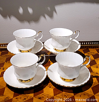 Set of four teacups on saucers showing overall condition and design