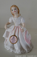 Front view of Royal Doulton Amanda figurine showing dress, face and tag