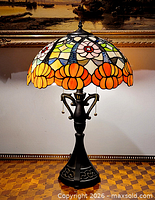 Full view of lamp lit showing shade pattern and base