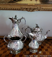Tall coffee pot, teapot, and open sugar bowl displayed together