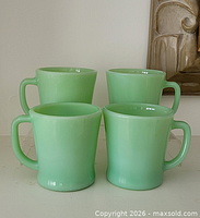 Front view of four jadeite mugs