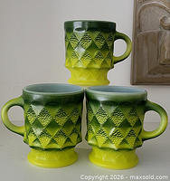 Three Fire-King Kimberly avocado green mugs front view