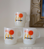 Three stacked Fire-King McDonald’s mugs showing front graphics