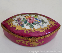 Overall view showing pink porcelain box, floral lid painting, ormolu mounts