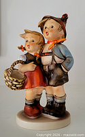 Front view of Goebel Hummel boy and girl figurine with basket