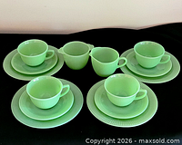 Full 14-piece jadeite tea set displayed