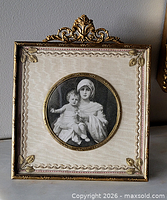 Front view of ornate brass photo frame with portrait