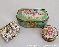 Three trinket boxes closed to show size and decoration