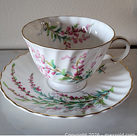 Teacup on saucer showing Bell Heather floral pattern and gold rim