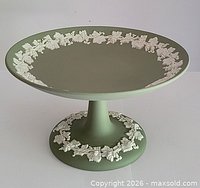 Side view of green jasperware comport showing pedestal and white grapevine relief