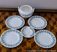 Group view of all six pieces: sugar bowl base, four larger plates, one smaller plate