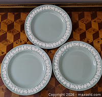 Three celadon green Wedgwood plates with white embossed rim
