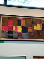 Full view of framed abstract painting on wall