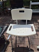 Front view of shower seat showing seat, backrest and legs
