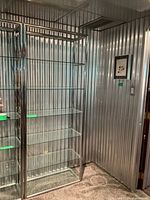 Full view of chrome and glass étagère showing frame and six shelves