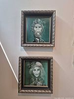 Two framed teal-green Endre Szasz portrait prints hung vertically
