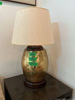 Full view of brass and wood table lamp with shade