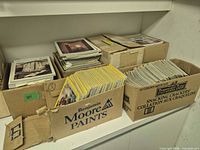 Three boxes of assorted magazines, stacks visible