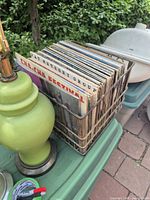 Top view of wire crate filled with LP records beside a green lamp