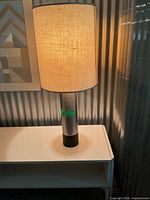 Full view of illuminated lamp on table showing overall design