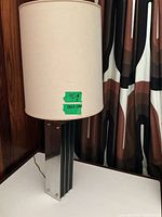Full view of lamp showing drum shade and fin column base